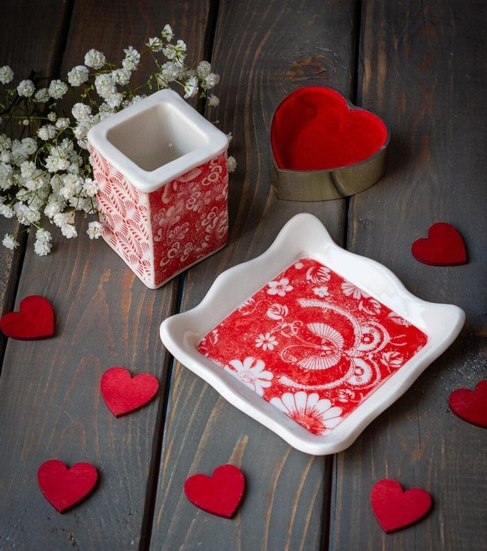 A red and white tray with a candle holder