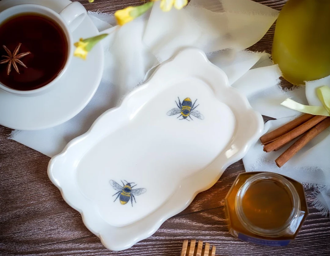 A table with a tray and cups of tea.