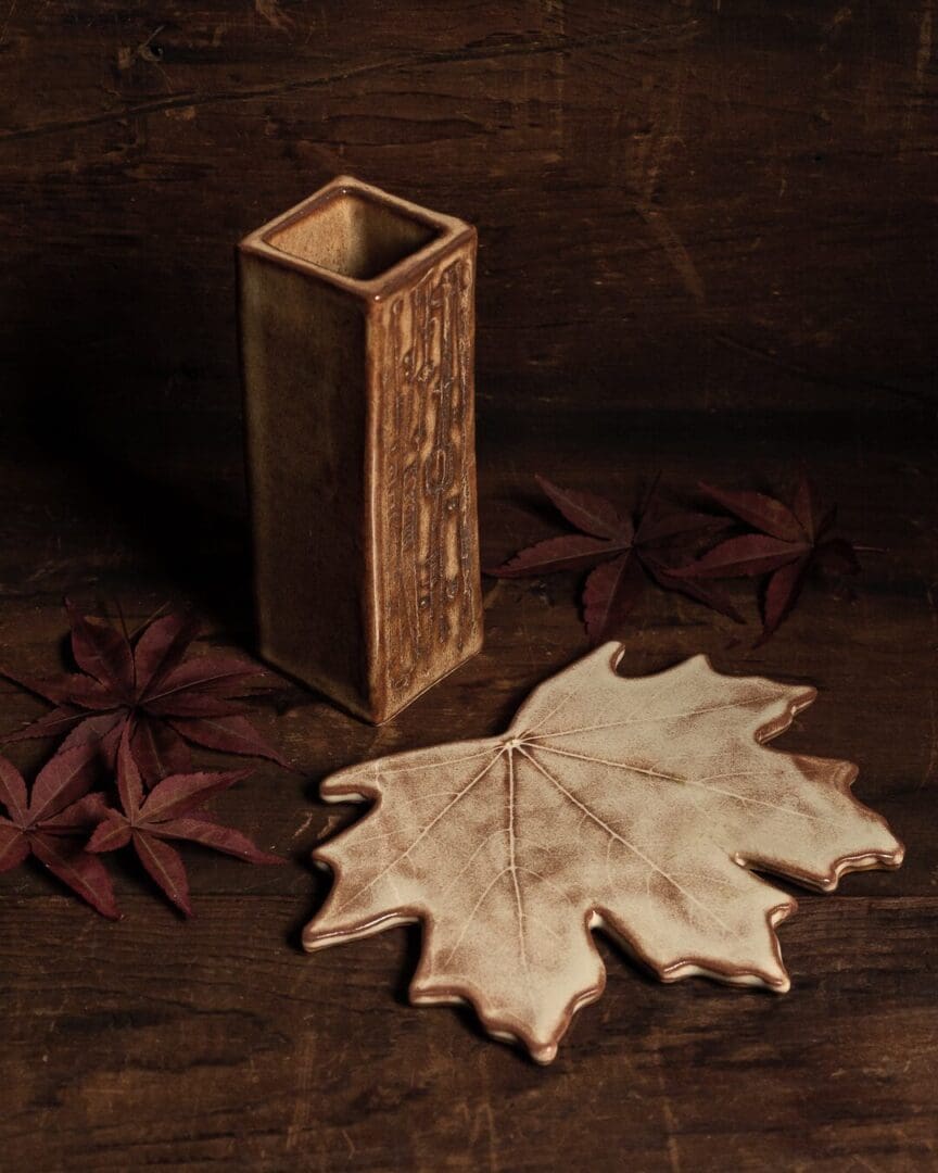 A wooden box and some leaves on the ground