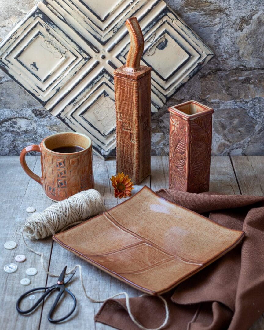 A table with some brown cups and plates