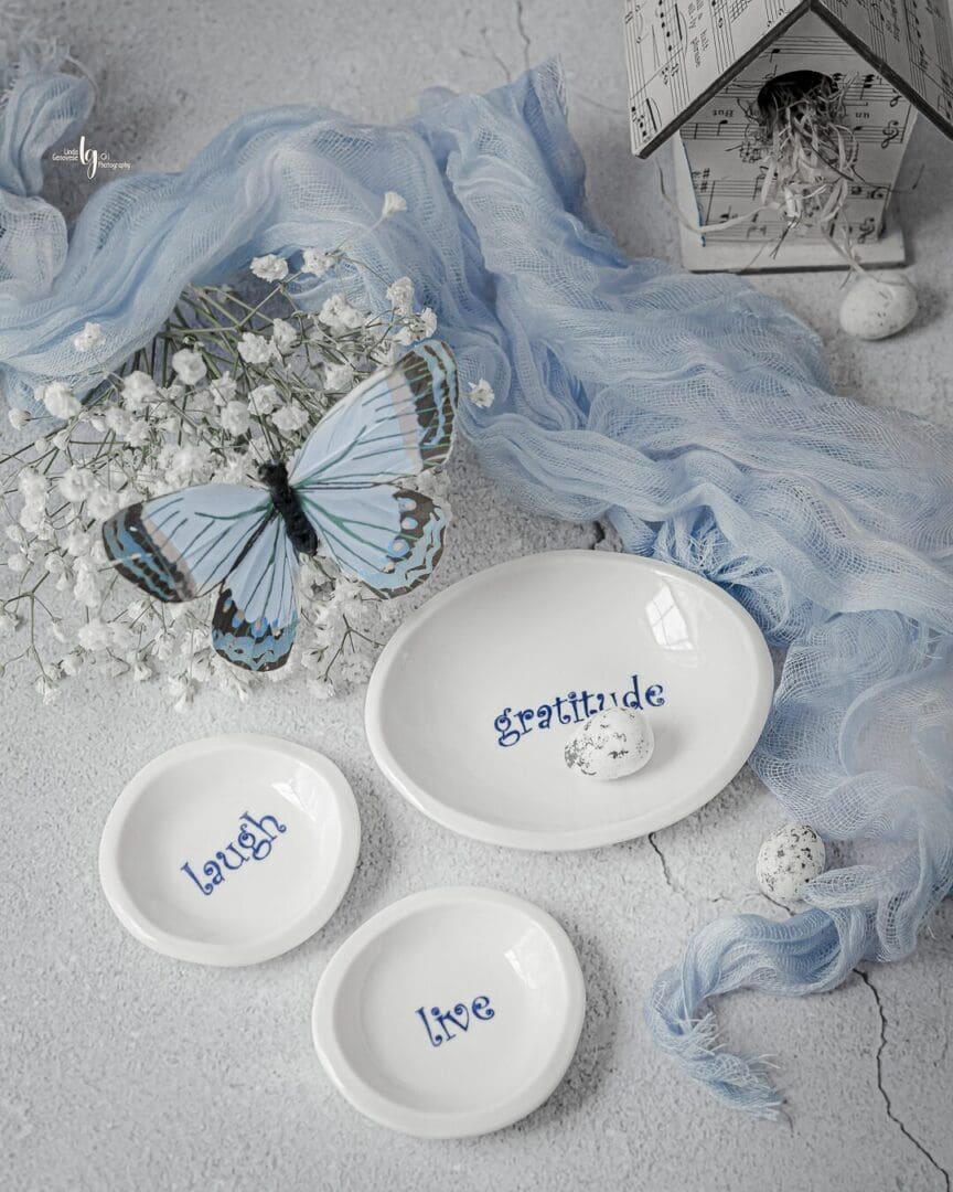 A table with three white dishes and blue writing.